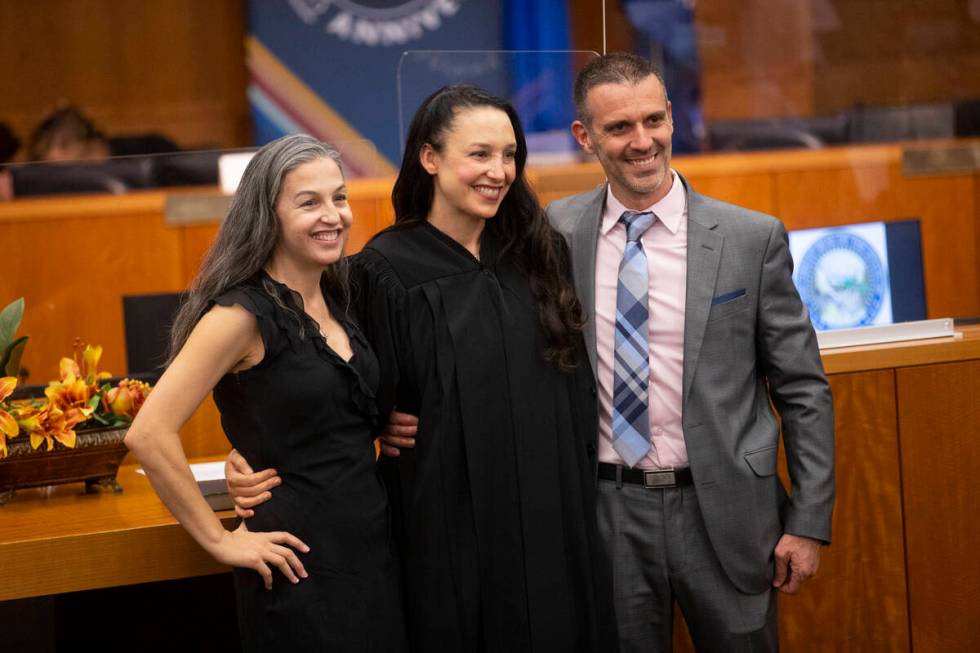 Judge Nadia Krall, center, with her husband Stephen, and sister Natalie Hudson, pose for a phot ...