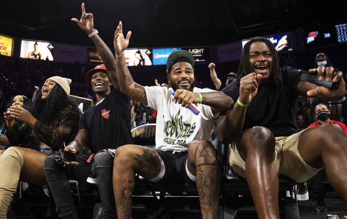 Raiders players Henry Ruggs III, Keisean Nixon and John Simpson cheer for the Aces in the first ...