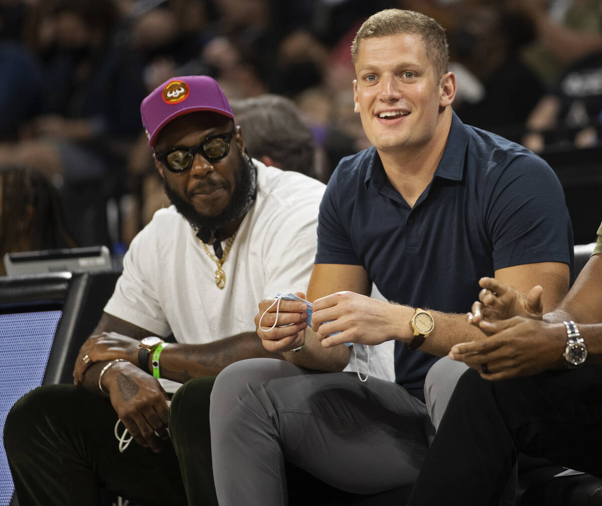 Raiders defensive end Carl Paul Nassib, right, takes in the action between the Las Vegas Aces a ...
