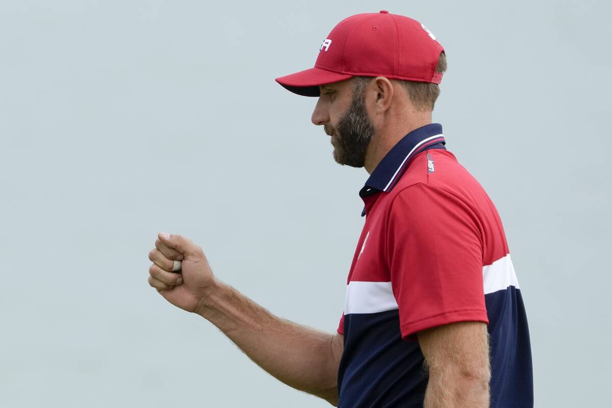 Team USA's Dustin Johnson reacts after his putt on the third hole during a Ryder Cup singles ma ...