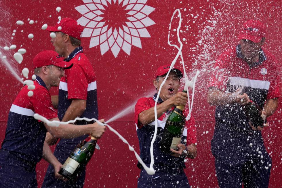 Team USA players celebrate after the Ryder Cup matches at the Whistling Straits Golf Course Sun ...