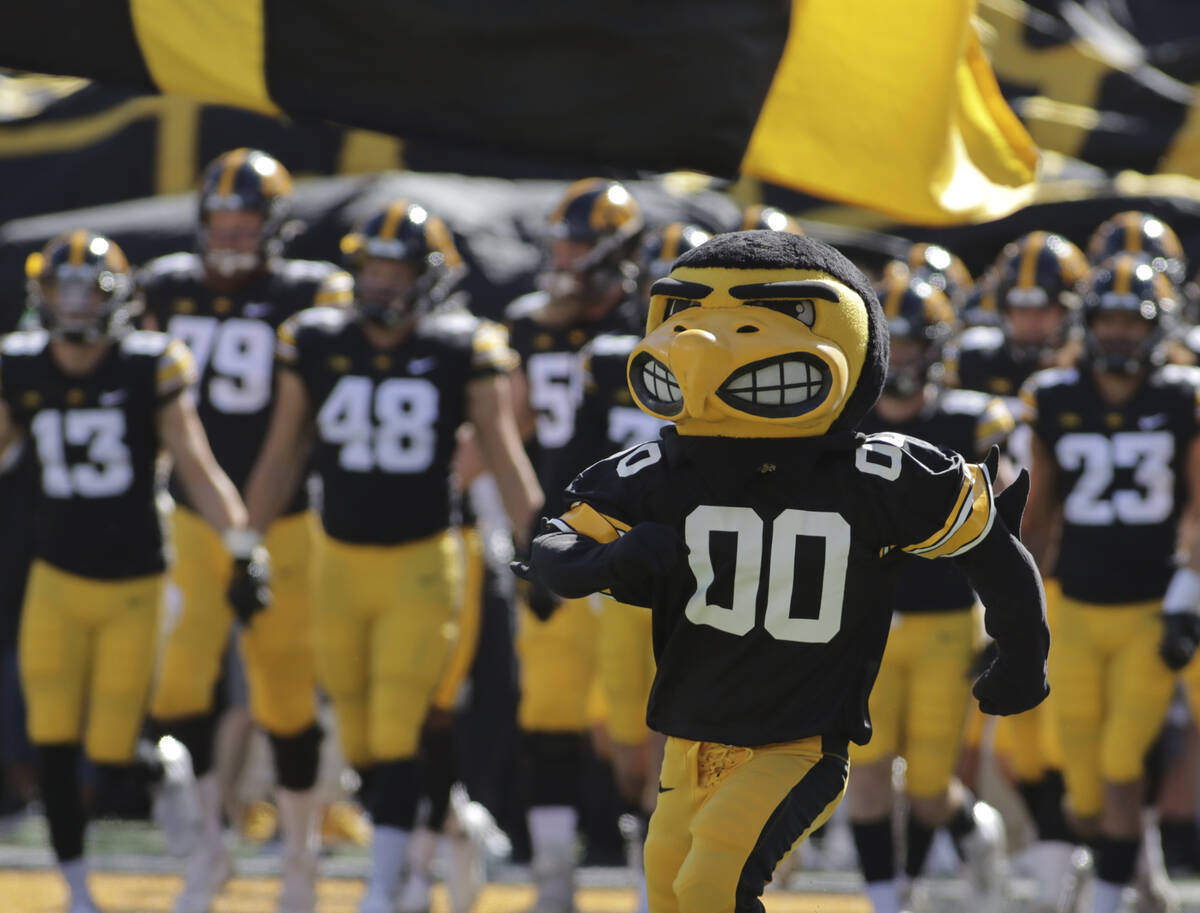 The Iowa Hawkeyes mascot runs onto the field, leading the team before the start of an NCAA coll ...