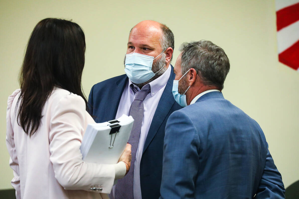 Attorney Jason Earnest, center, speaks fellow defense attorneys Nadine Morton, left, and Thomas ...