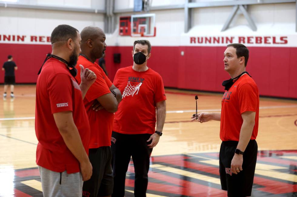 UNLV coach Kevin Kruger, right, talks with, from left, DeShawn Henry, director of basketball op ...