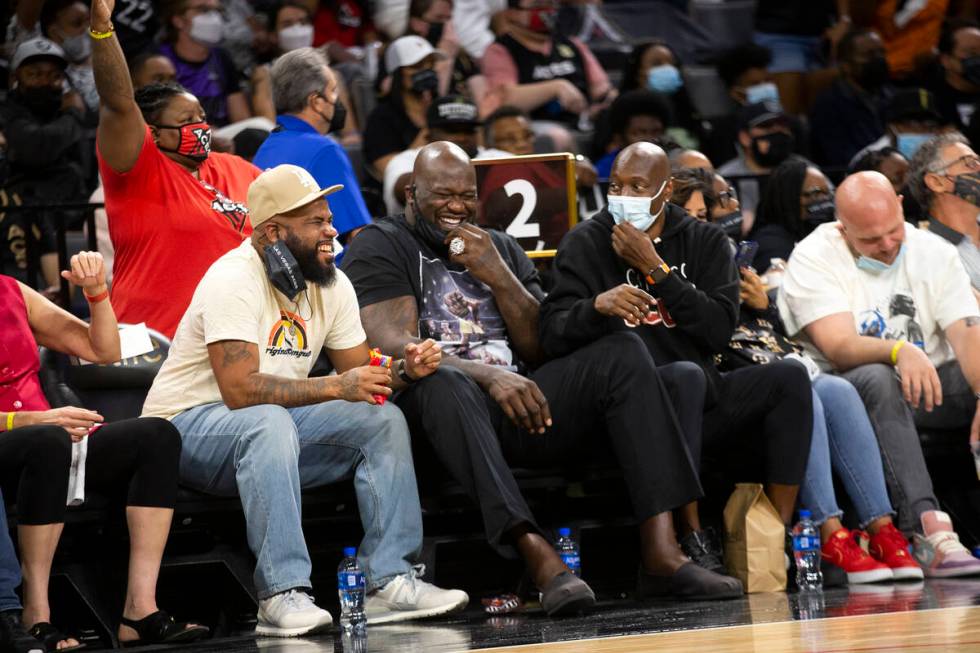 Shaquille O'Neal, center, laughs while attending game 2 of a WNBA semifinal game between the La ...