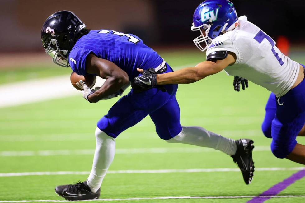 Desert Pines' Lavon Brown (3) makes a catch under pressure from Green Valley's Anton Keeling (7 ...