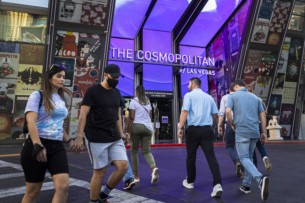 Pedestrians walk outside The Cosmopolitan of Las Vegas on Sept. 27, 2021. (Benjamin Hager/Las V ...