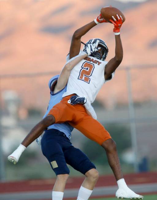 Legacy High School's Montae Pate (2) catches a pass as Jason Fisher (20), behind, tries to stop ...