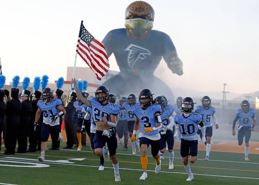 Foothill High School's players run out to the field before a football game against Legacy High ...