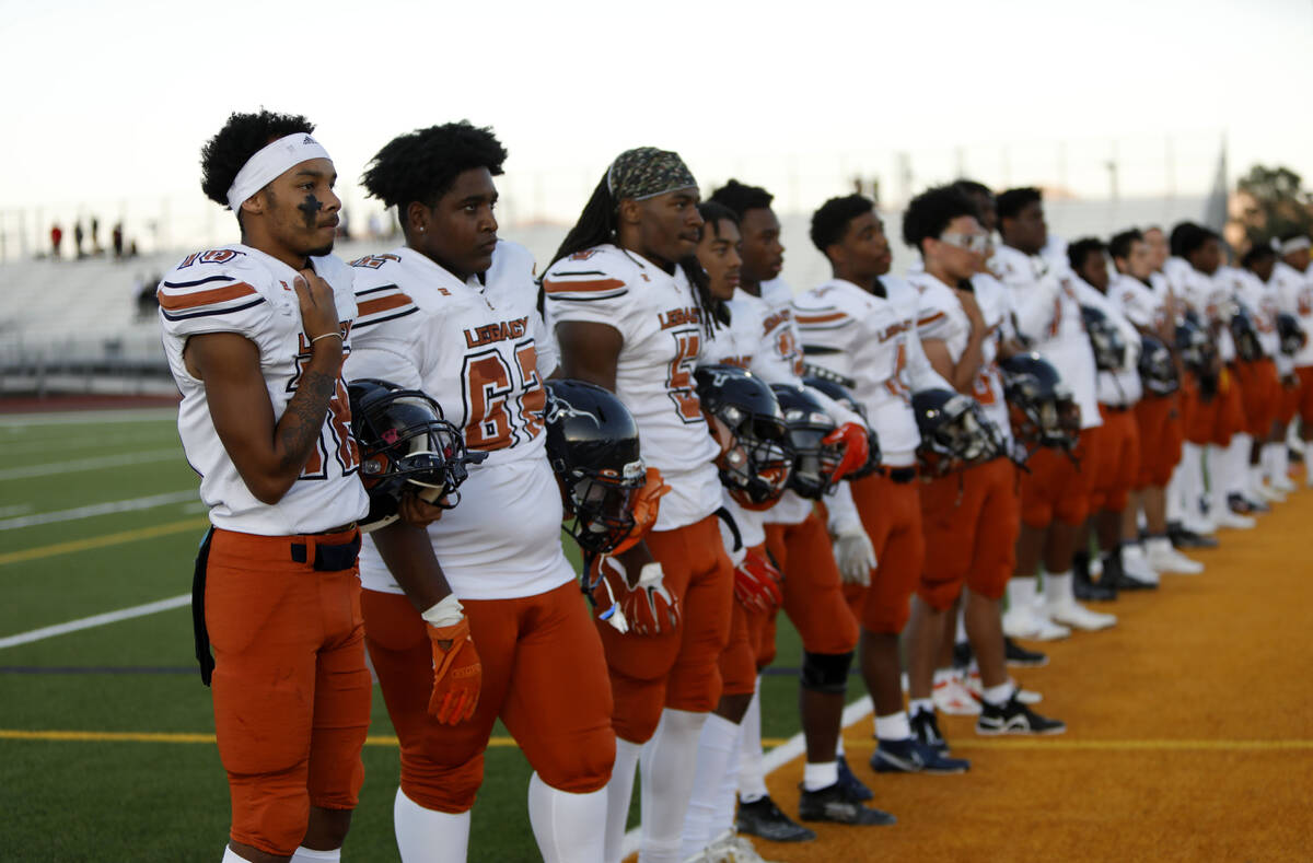 Legacy High School's players line up for the national anthem before a football game against Foo ...