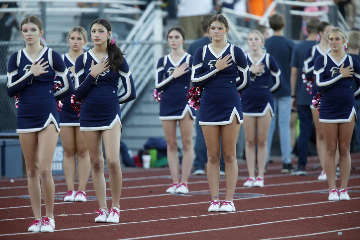 Foothill High School's cheerleaders line up for the national anthem before a football game agai ...