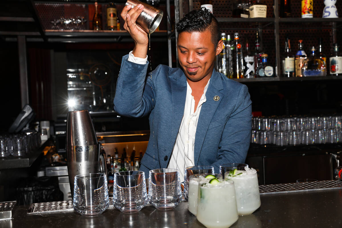 Ricky Lin, director of sales for Singani 63, left, pours the cocktail ÒPermissionÓ&#x ...