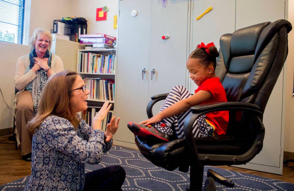 Client Hannah Beal, 4, and Julie Cole, a speech-language pathologist, engage in play therapy at ...