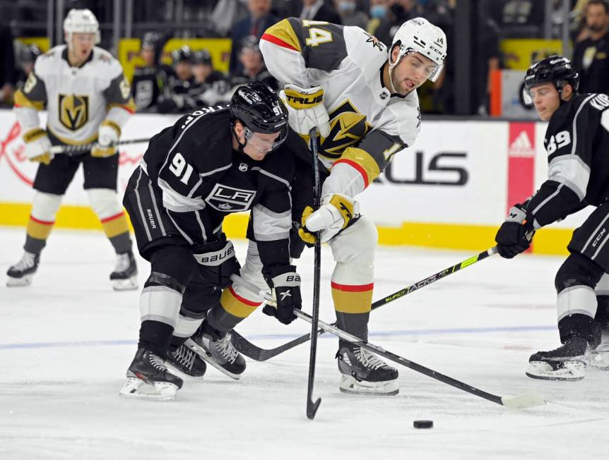 Los Angeles Kings left wing Carl Grundstrom (91) and Vegas Golden Knights defenseman Nicolas Ha ...