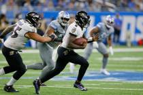 Baltimore Ravens quarterback Lamar Jackson (8) scrambles against the Detroit Lions in the secon ...