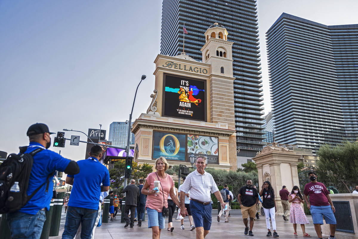 Pedestrians walk past Bellagio on Monday, Sept. 27, 2021, in Las Vegas. (Benjamin Hager/Las Veg ...