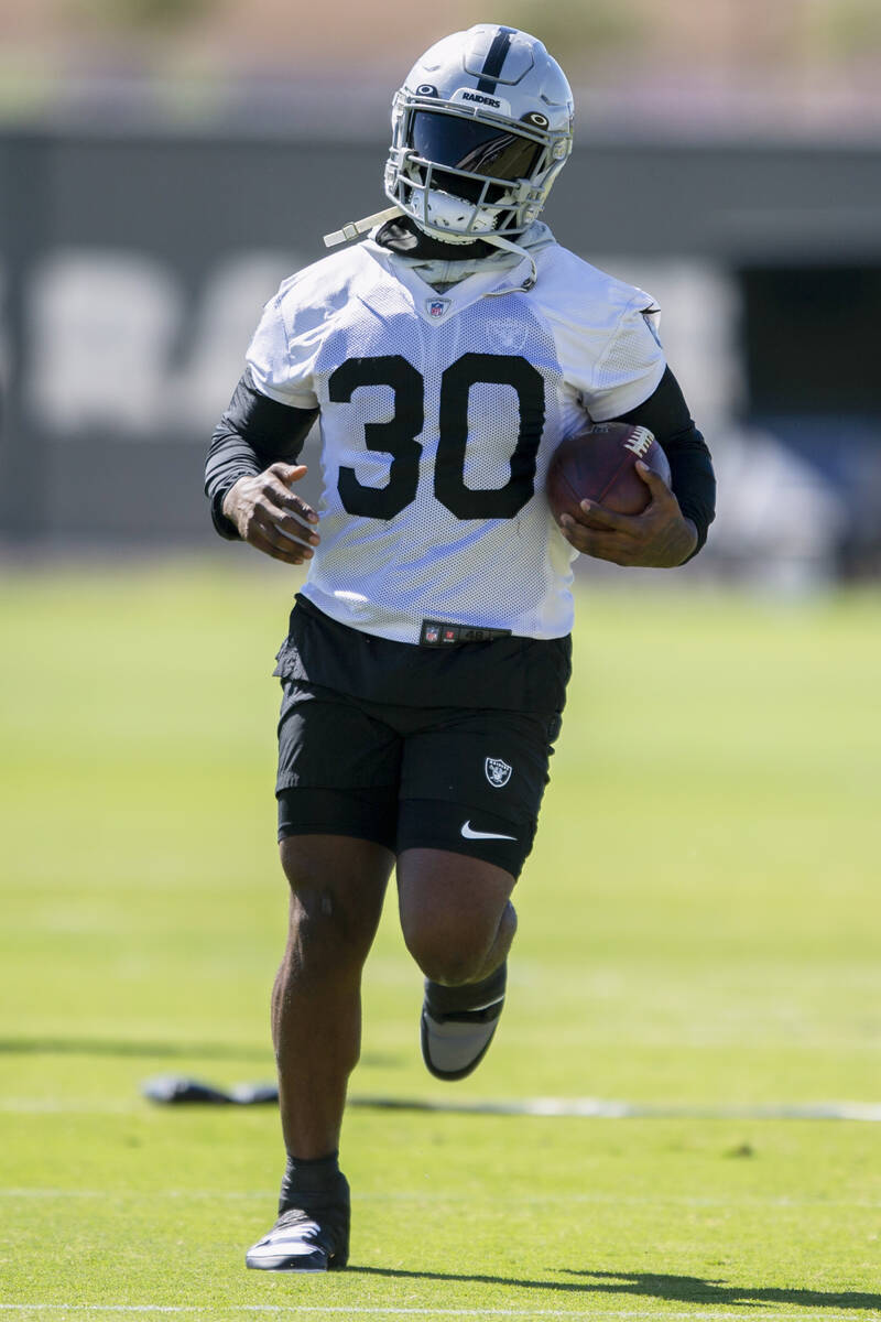 Raiders running back Jalen Richard (30) runs with the football during a practice session at the ...