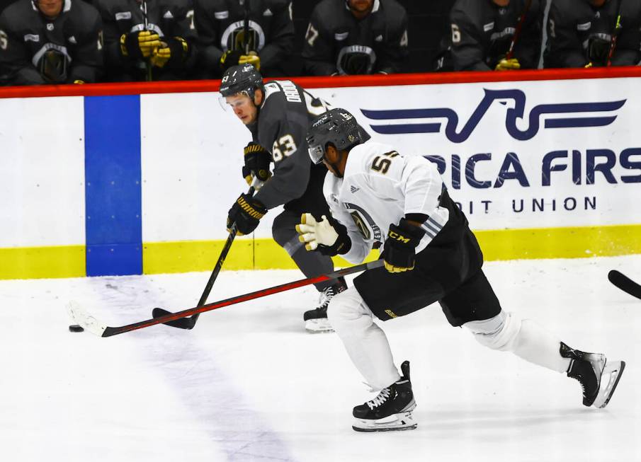 Golden Knights' Evgenii Dadonov (63) skates with the puck under pressure from Keegan Kolesar (5 ...