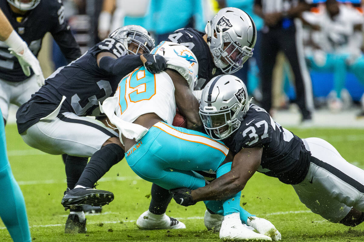 Miami Dolphins wide receiver Jakeem Grant (19) is stopped by Raiders cornerback Nate Hobbs (39) ...
