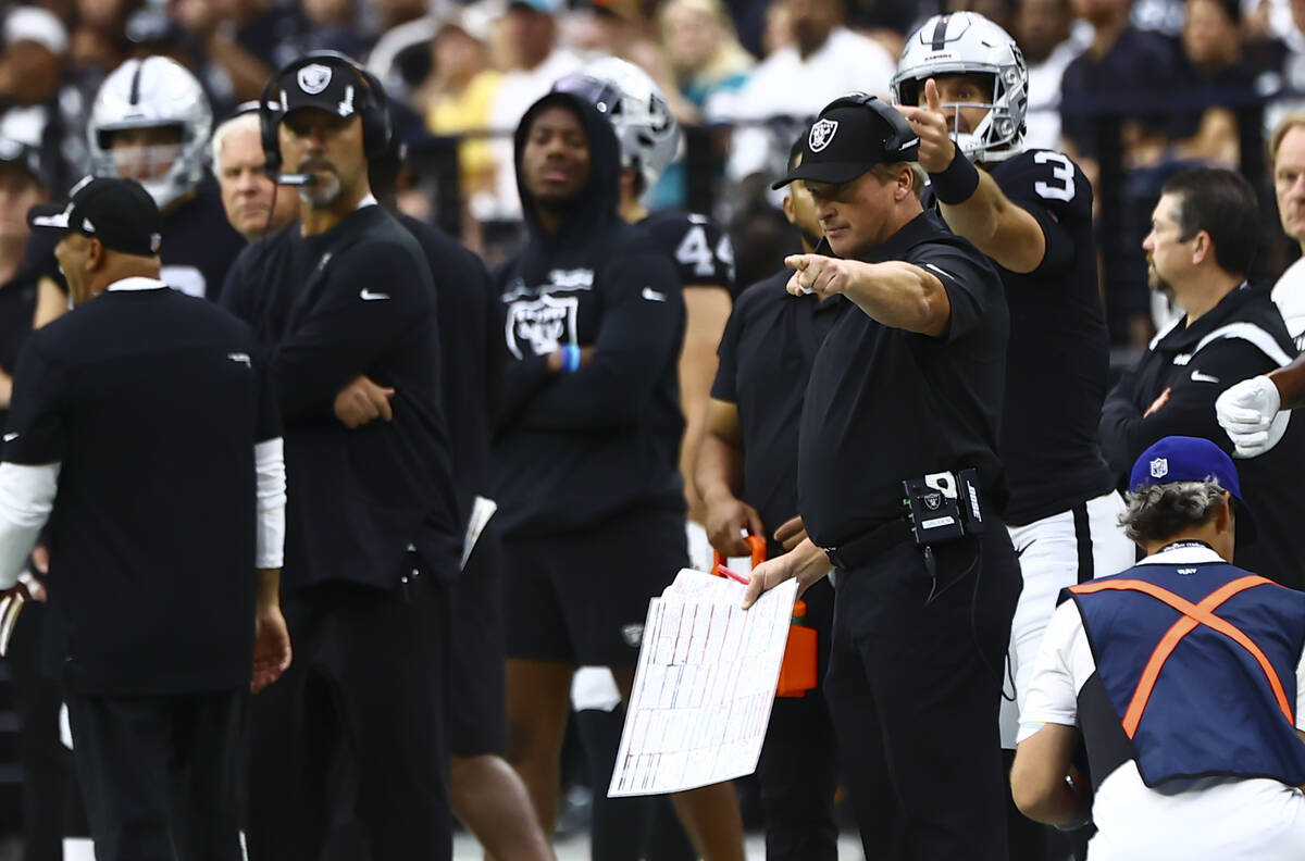 Raiders head coach Jon Gruden motions to his team during the first half of NFL game against the ...