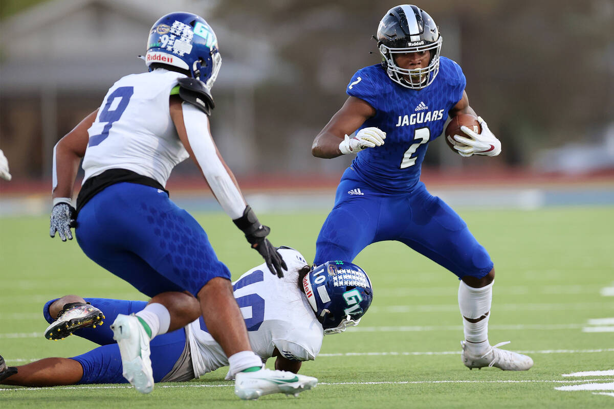 Desert Pines' Javontae Barnes (2) is tackled by Green Valley's Sonny Vitale (10) in the first h ...