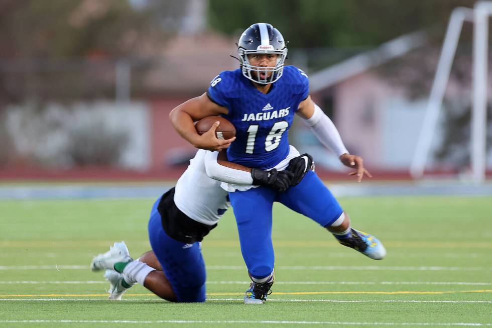 Desert Pines' Eddie Sandoval (18) is sacked by Green Valley's Mathius Aleaga (9) in the first h ...