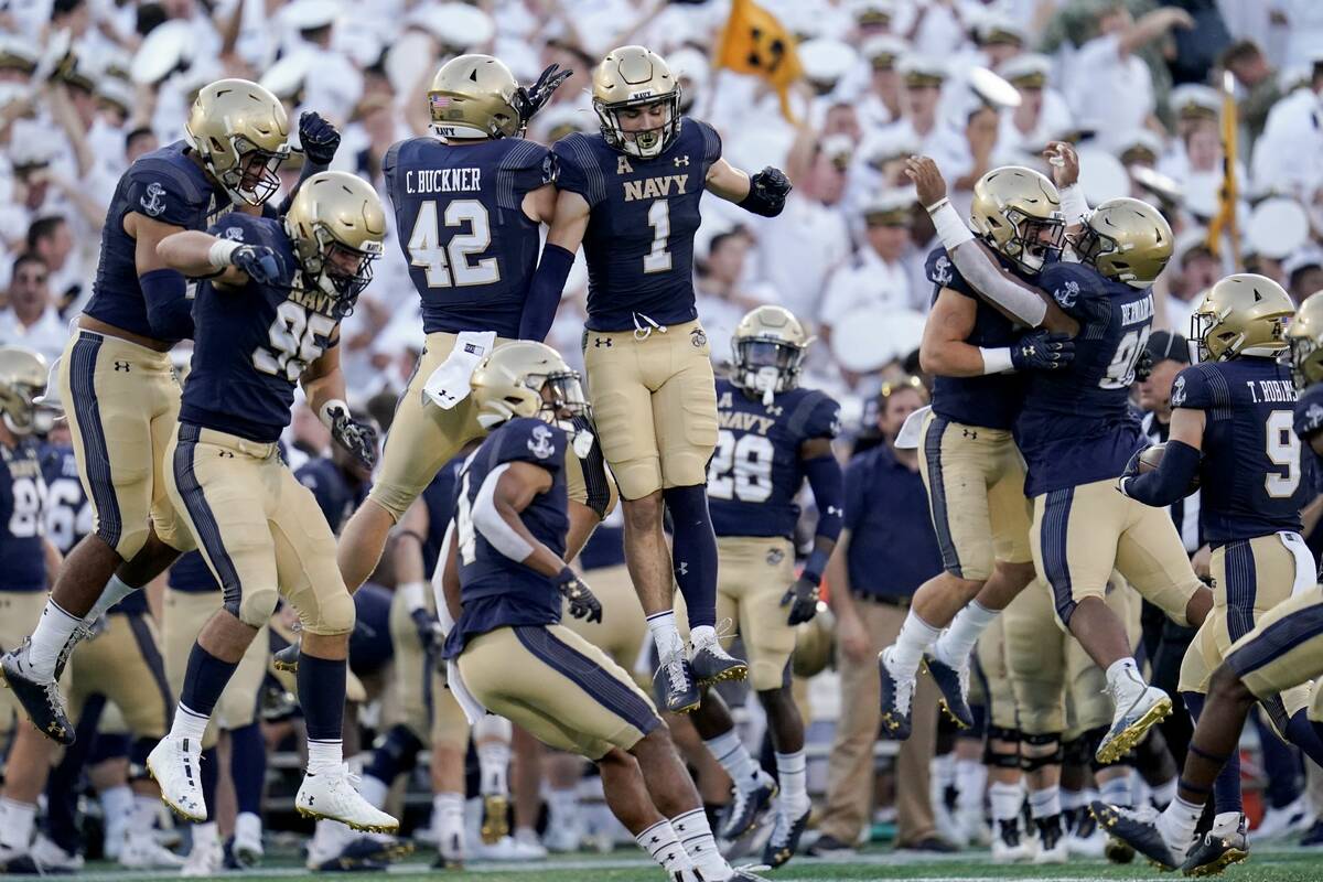 Navy players celebrate after they recovered a fumble by UCF during the second half of an NCAA c ...