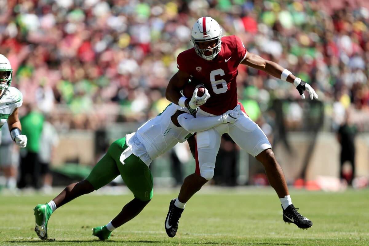 Stanford's Elijah Higgins runs after a catch against Oregons' Mykael Wright during the first ha ...