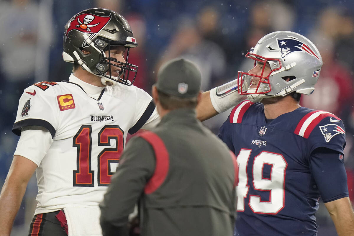 Tampa Bay Buccaneers quarterback Tom Brady (12) meets with New England Patriots long snapper Jo ...