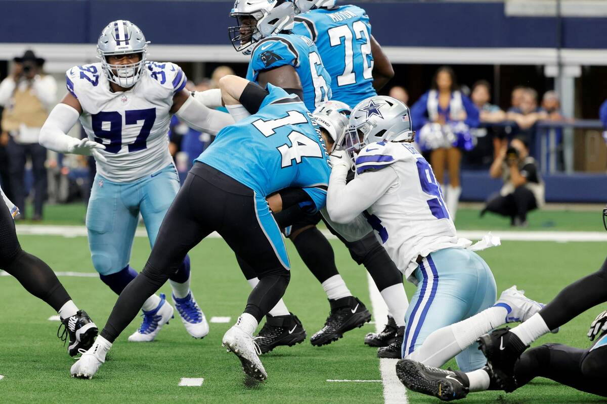 Carolina Panthers quarterback Sam Darnold (14) is sacked by Dallas Cowboys defensive end Randy ...