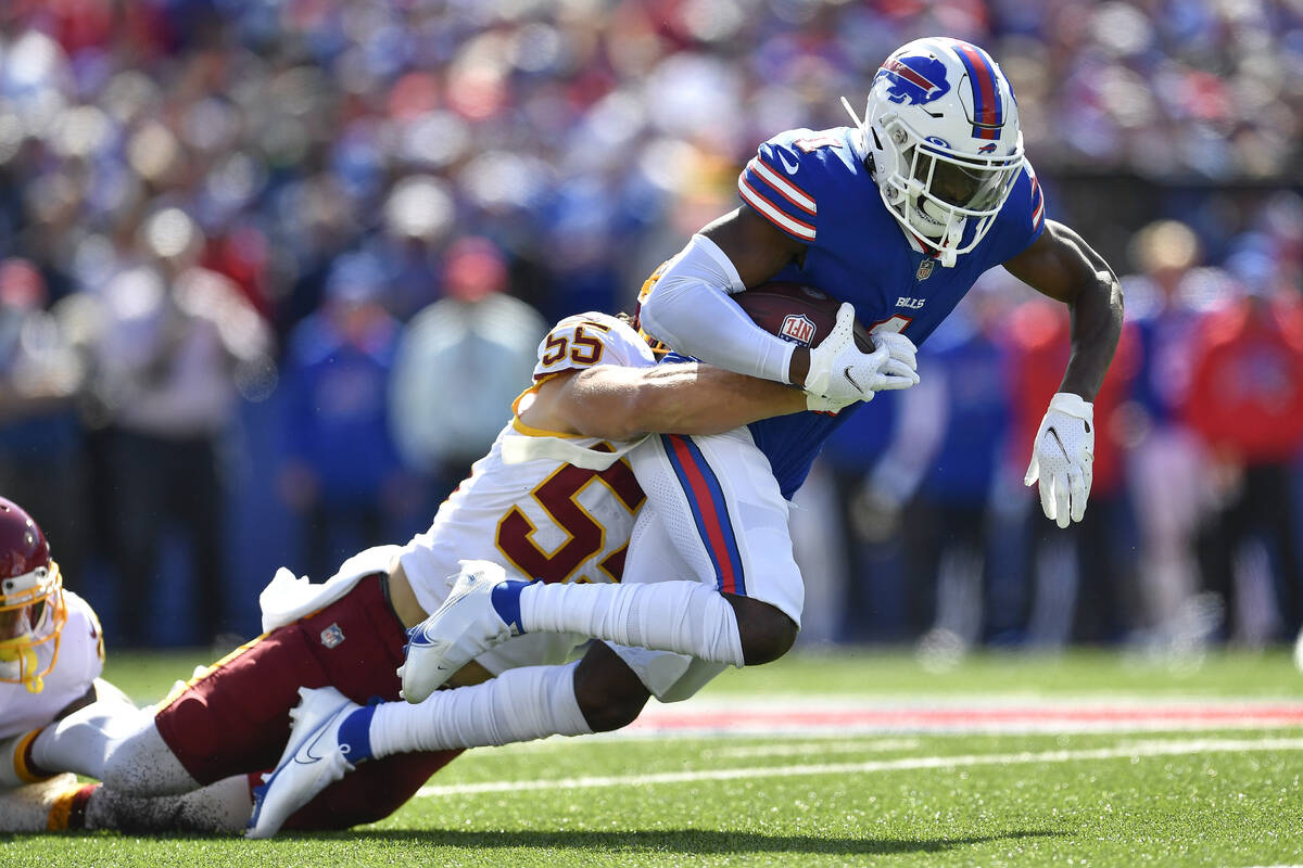 Buffalo Bills wide receiver Emmanuel Sanders (1) is tackled by Washington Football Team linebac ...