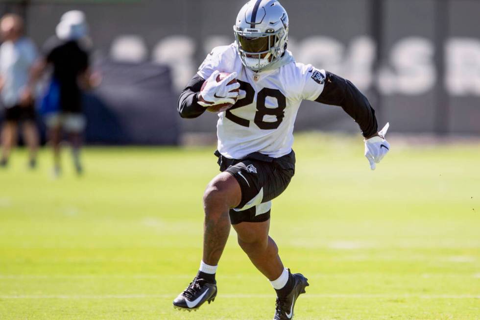 Raiders running back Josh Jacobs (28) runs with the football during a practice session at the R ...