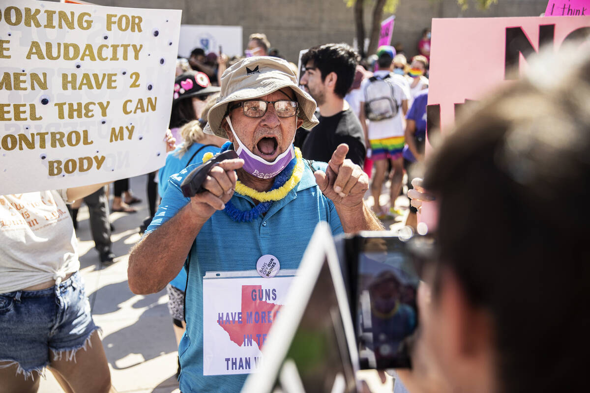 An argument breaks out between demonstrators outside the Lloyd D George Courthouse during a Mar ...