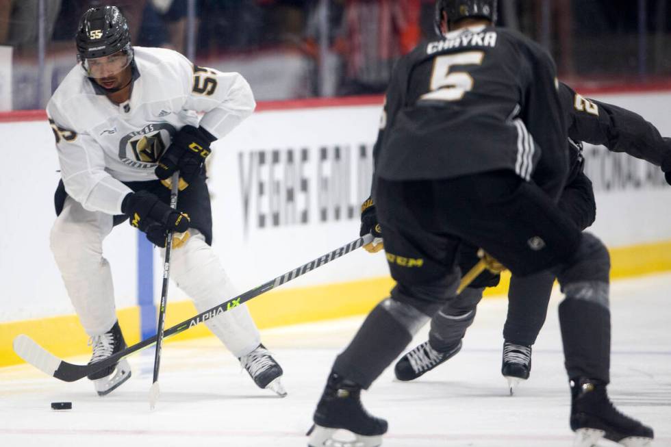 Golden Knights right wing Keegan Kolesar (55) skates around defenseman Daniil Chayka (5) during ...