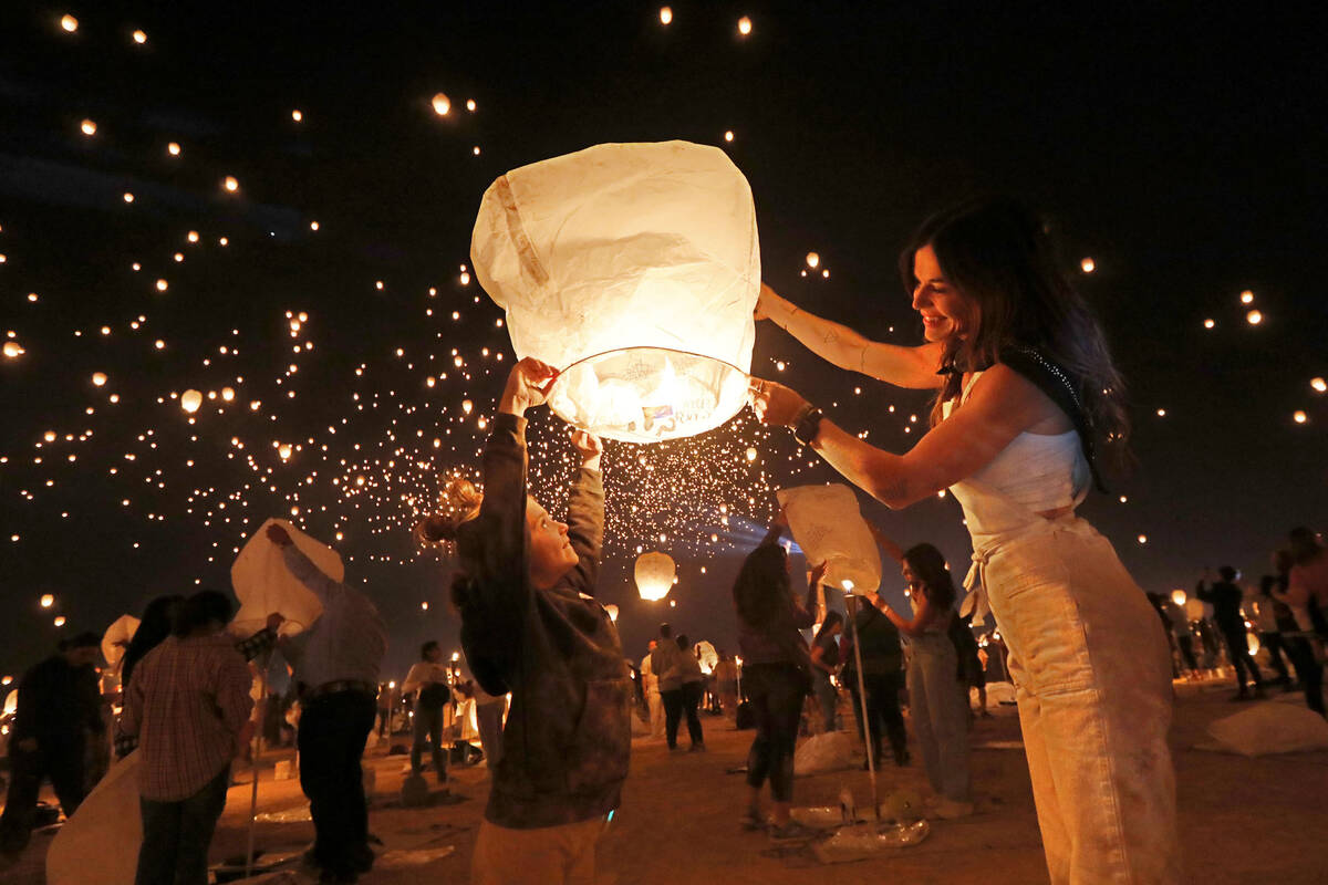 Luvia Williams, 8, of Scottsdale Ariz., left and her mother Whitney prepare their lantern for l ...