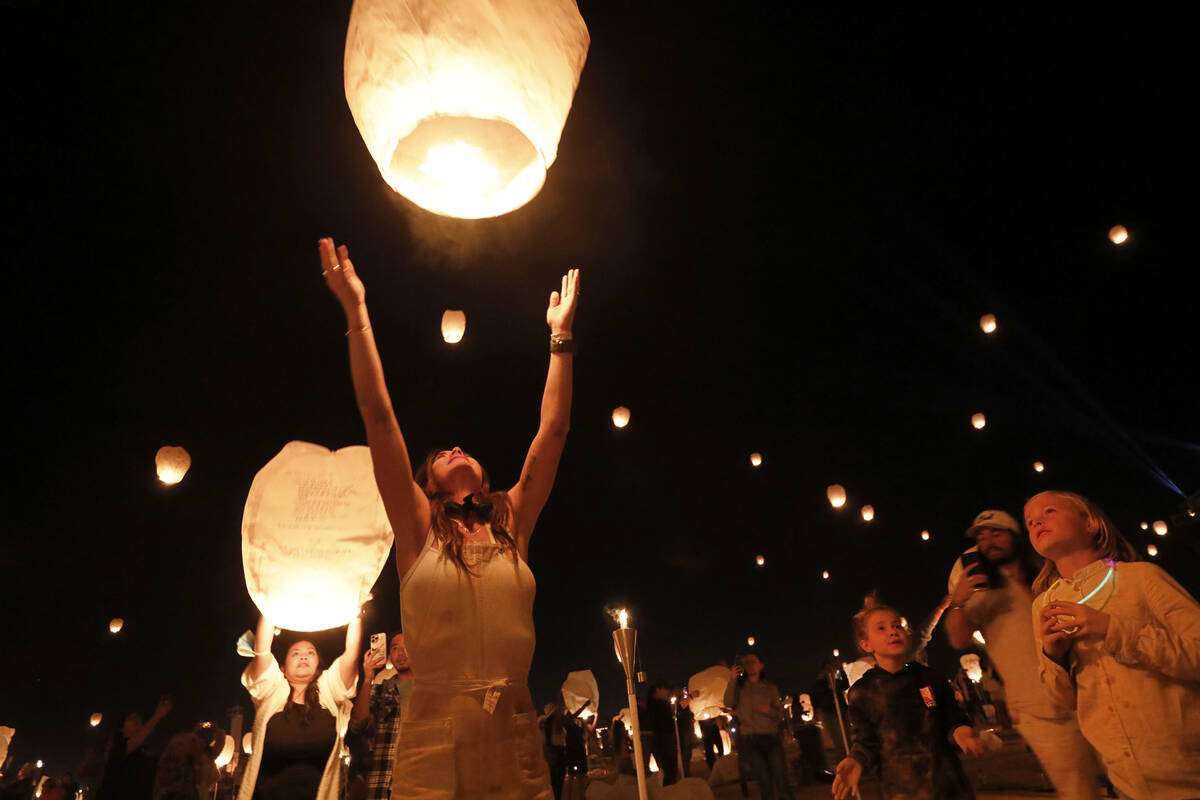 Whitney Williams of Scottsdale Ariz. releases her lantern at the Rise Festival in the Mojave D ...