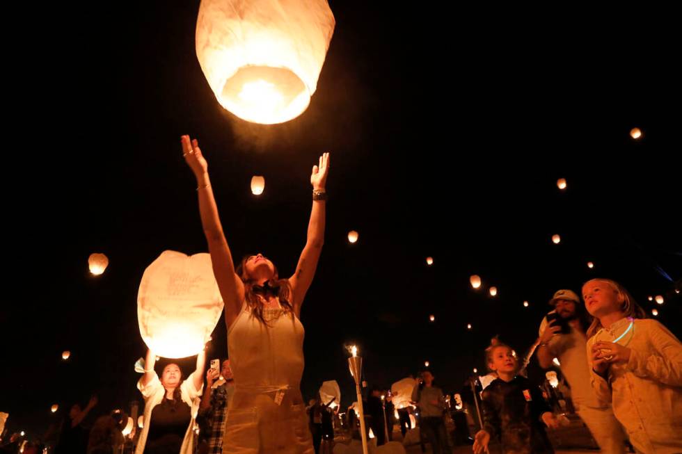 Whitney Williams of Scottsdale Ariz. releases her lantern at the Rise Festival in the Mojave D ...