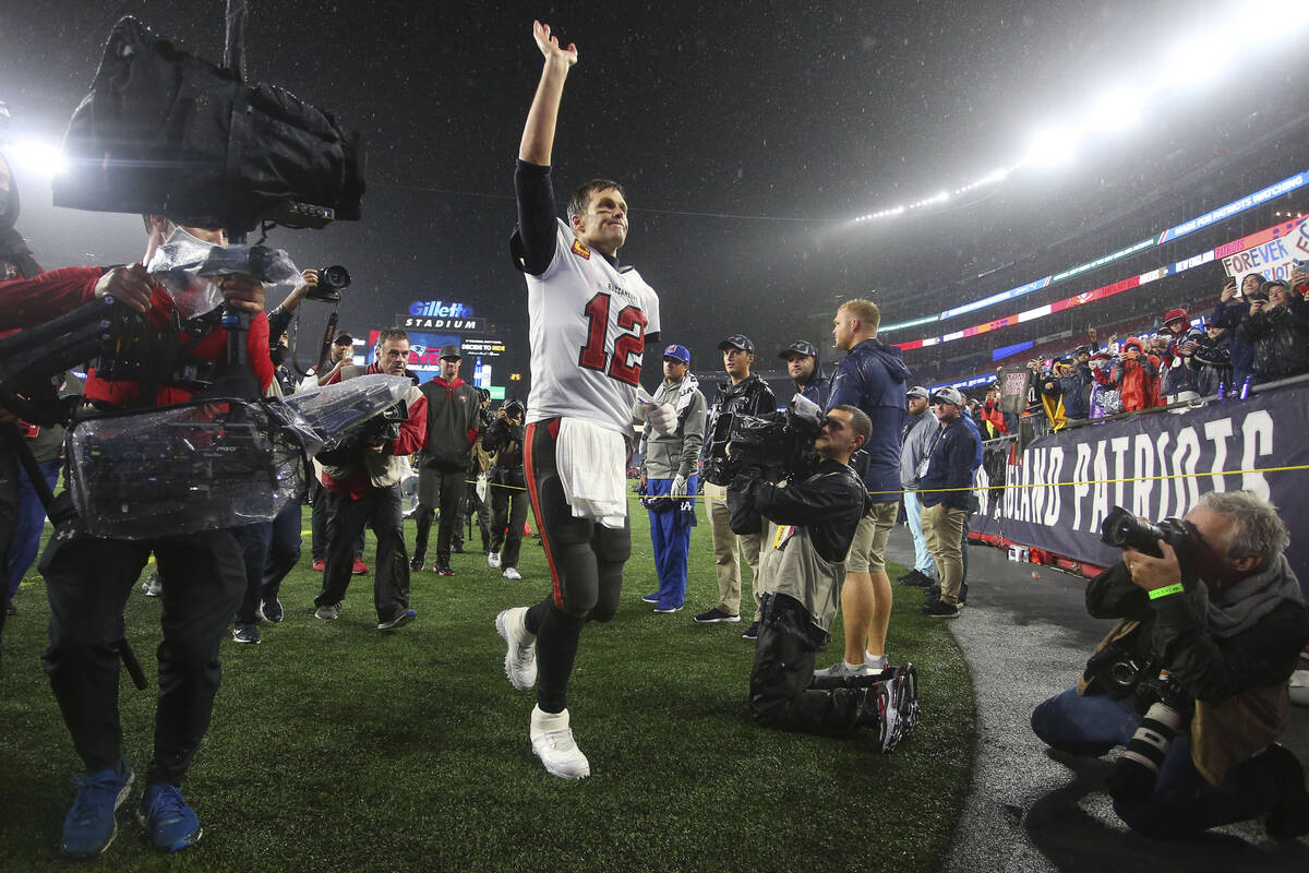 Tampa Bay Buccaneers quarterback Tom Brady (12) waves to the fans as he runs off the field foll ...