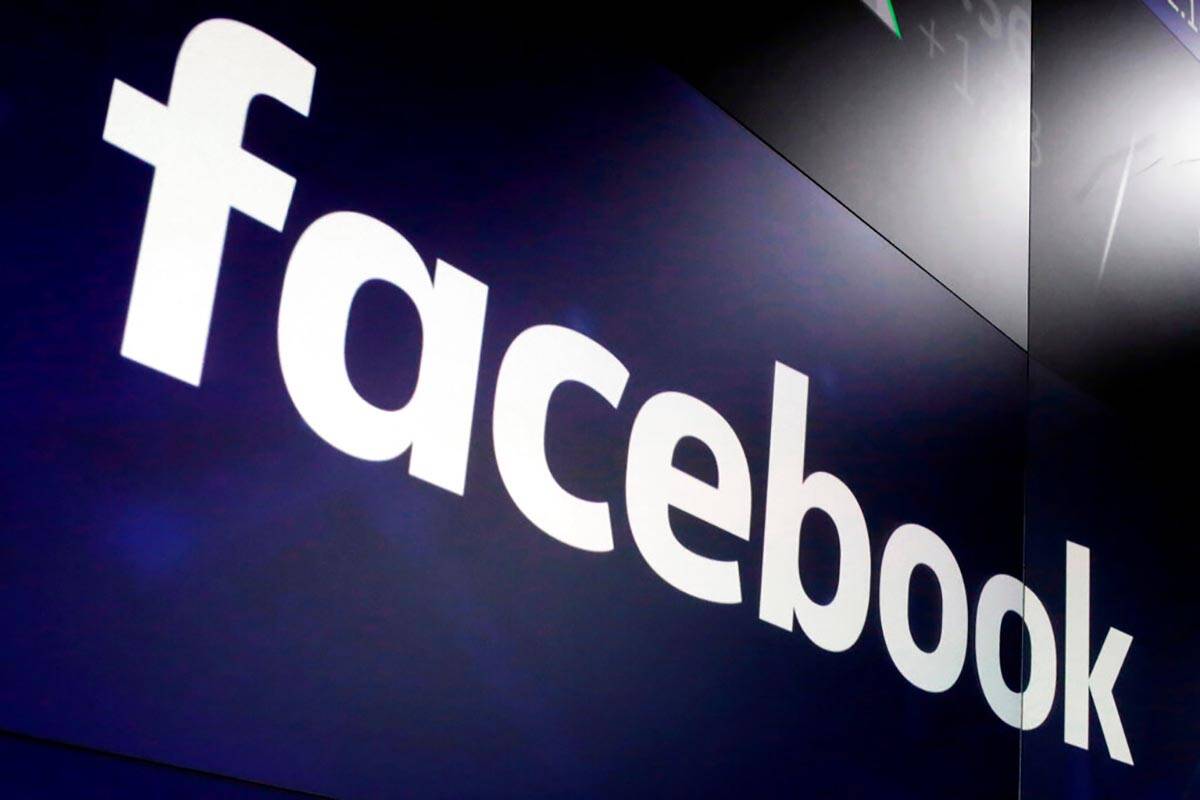 FILE - In this March 29, 2018, file photo, the logo for Facebook appears on screens at the Nasd ...