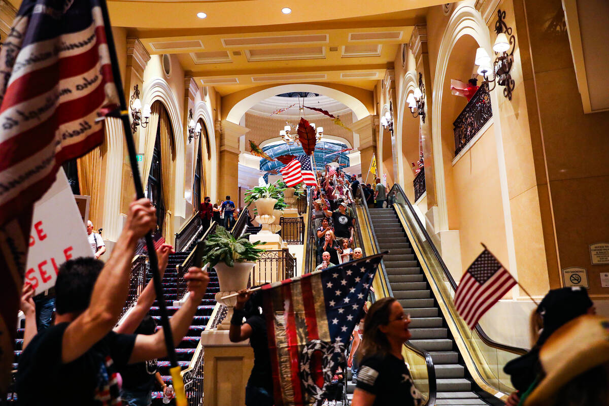 Protesters walk through the Bellagio to protest COVID-19 government mandates, hosted by the non ...