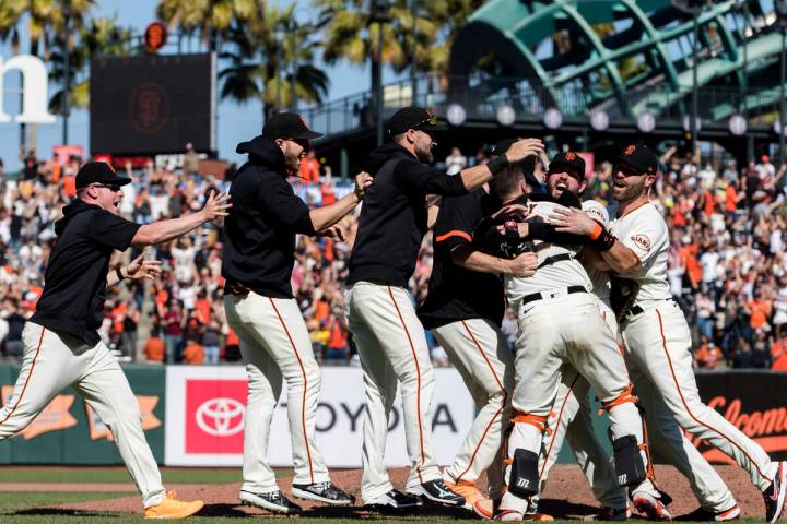 The San Francisco Giants celebrate after defeating the San Diego Padres in a baseball game in S ...