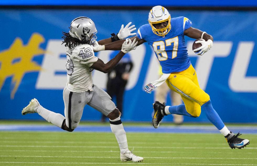 Los Angeles Chargers tight end Jared Cook (87) stiff arms Raiders inside linebacker Cory Little ...