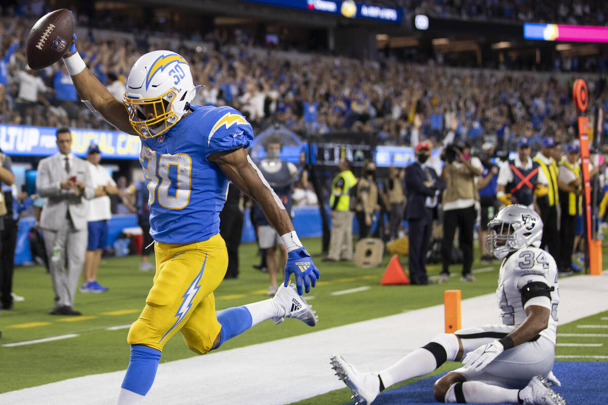 Los Angeles Chargers running back Austin Ekeler (30) scores a touchdown past Raiders outside li ...
