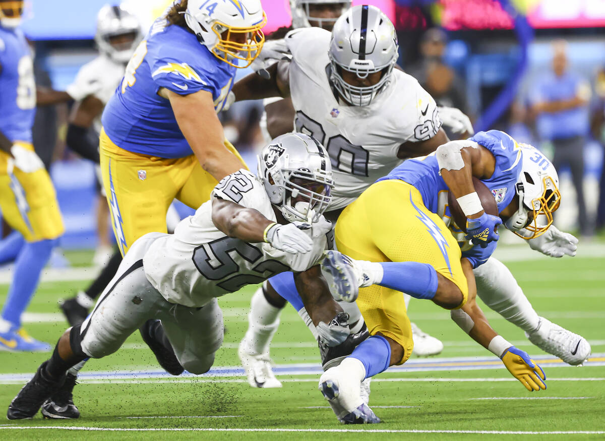 Raiders middle linebacker Denzel Perryman (52) tackles Los Angeles Chargers running back Austin ...