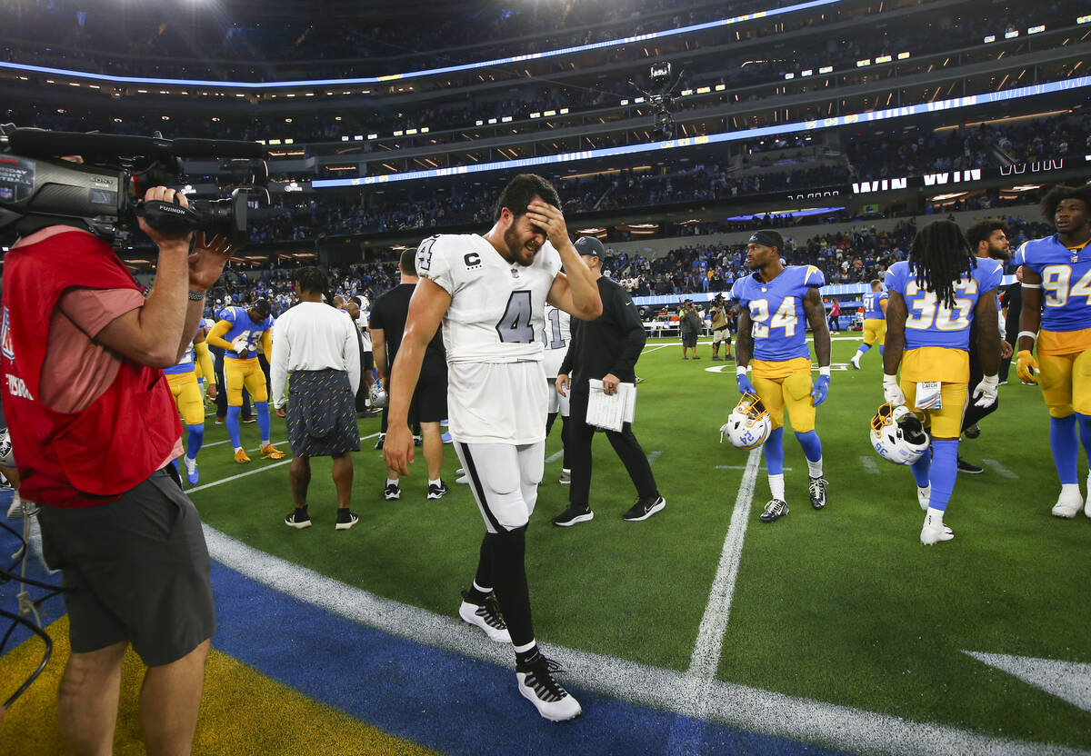 Raiders quarterback Derek Carr (4) heads off the field after a 28-14 loss to the Los Angeles Ch ...