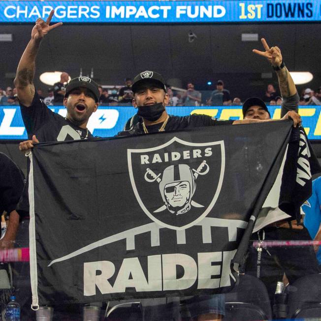 Raiders fans pose for a photo before an NFL football game between the Raiders and the Los Angel ...