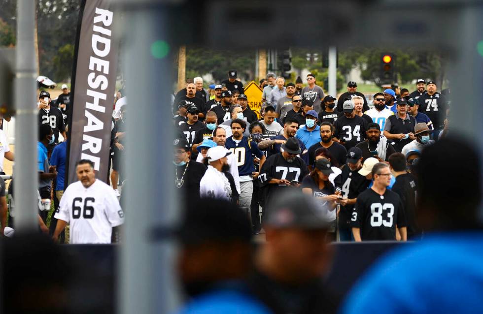 Raiders fans make their way to SoFi Stadium before the start of an NFL game against the Los Ang ...