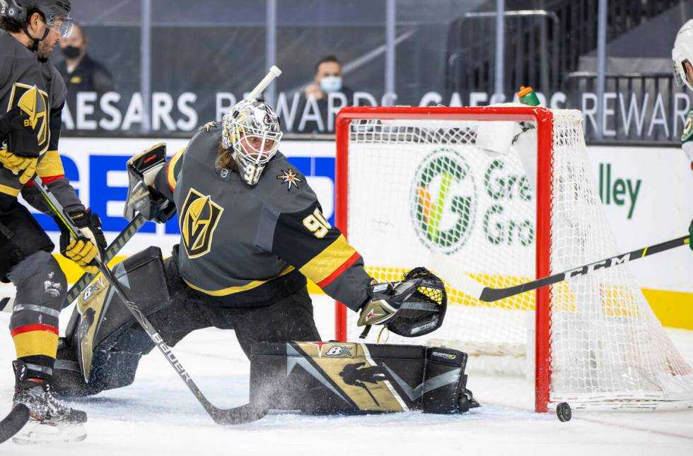 Golden Knights goaltender Robin Lehner (90) deflects a shot on Goa by the Minnesota Wild during ...