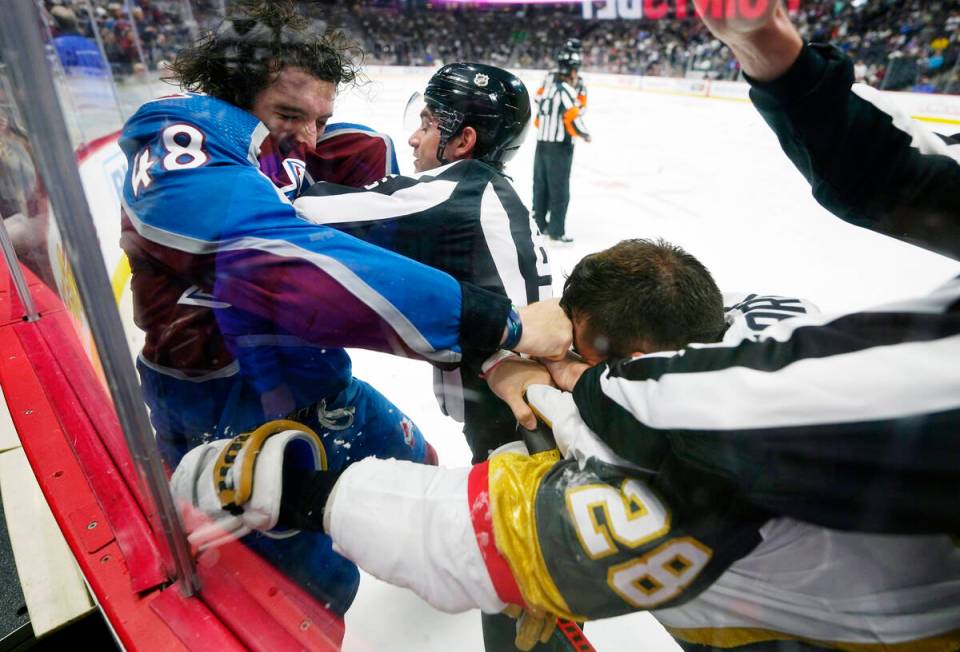 Colorado Avalanche defenseman Dennis Gilbert (48) punches Vegas Golden Knights left wing Willia ...