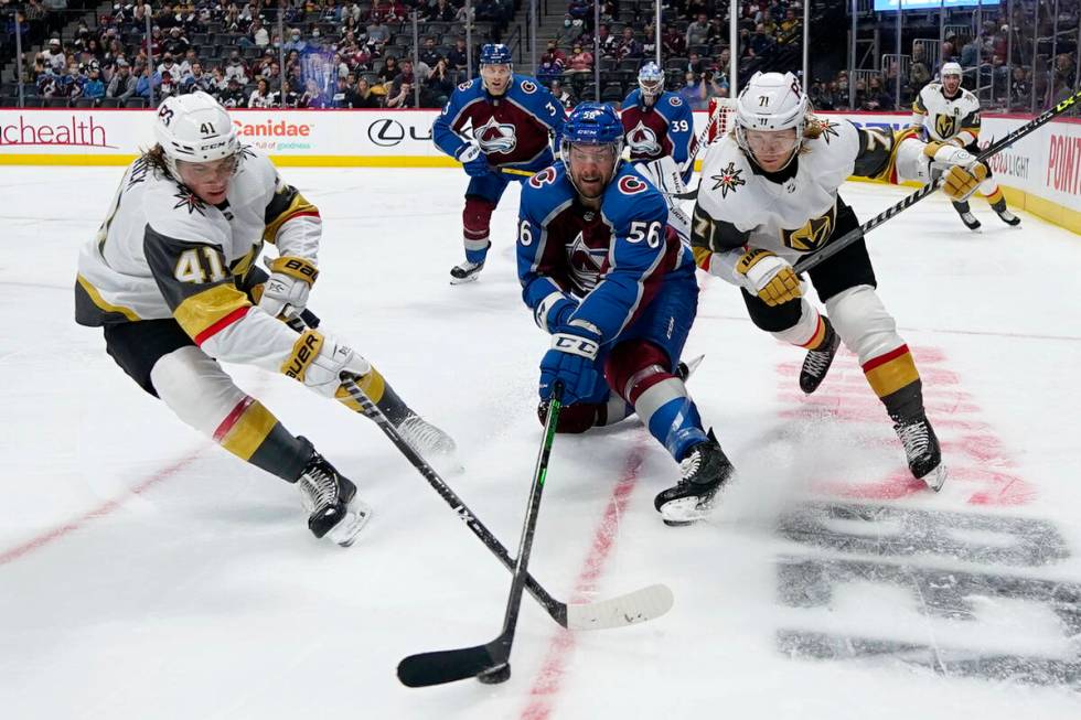 Colorado Avalanche defenseman Kurtis MacDermid (56) moves the puck under pressure from Vegas Go ...